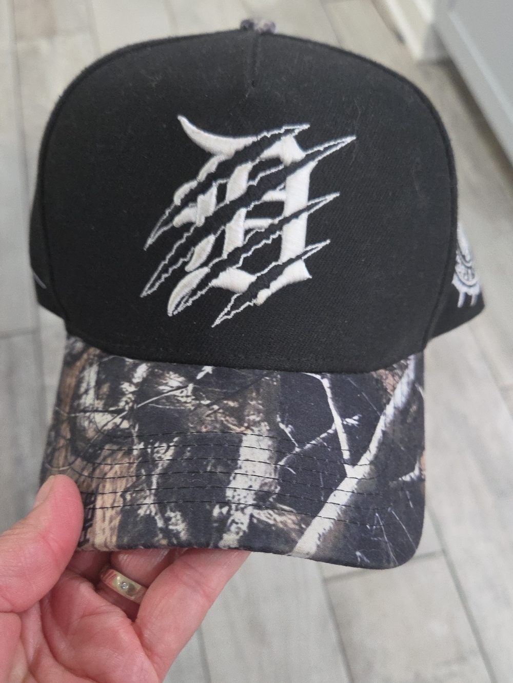 Source Unknown Black Cap with Camo Visor and White Claw Logo